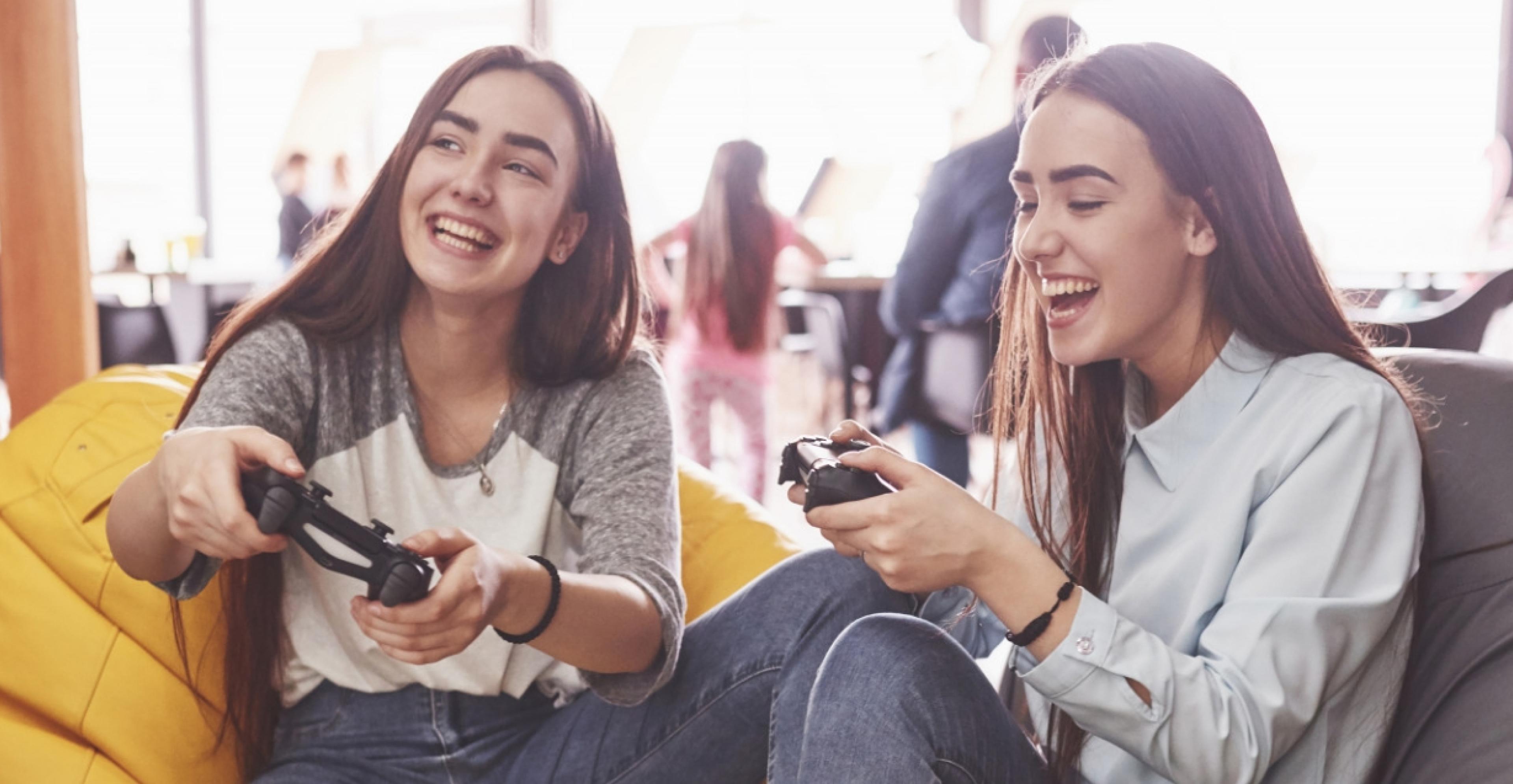 young females playing console game