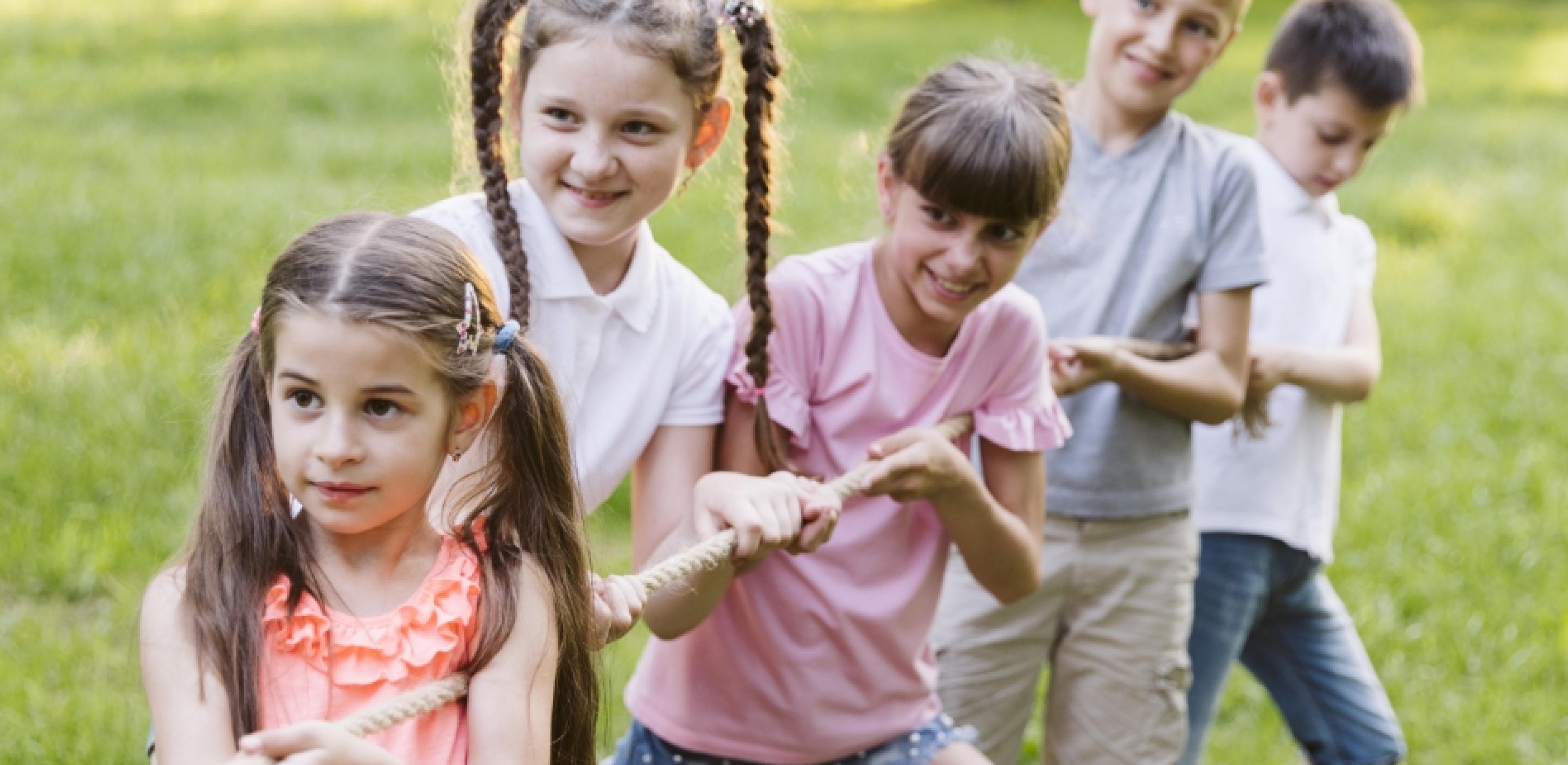 kids having fun playing tug of war