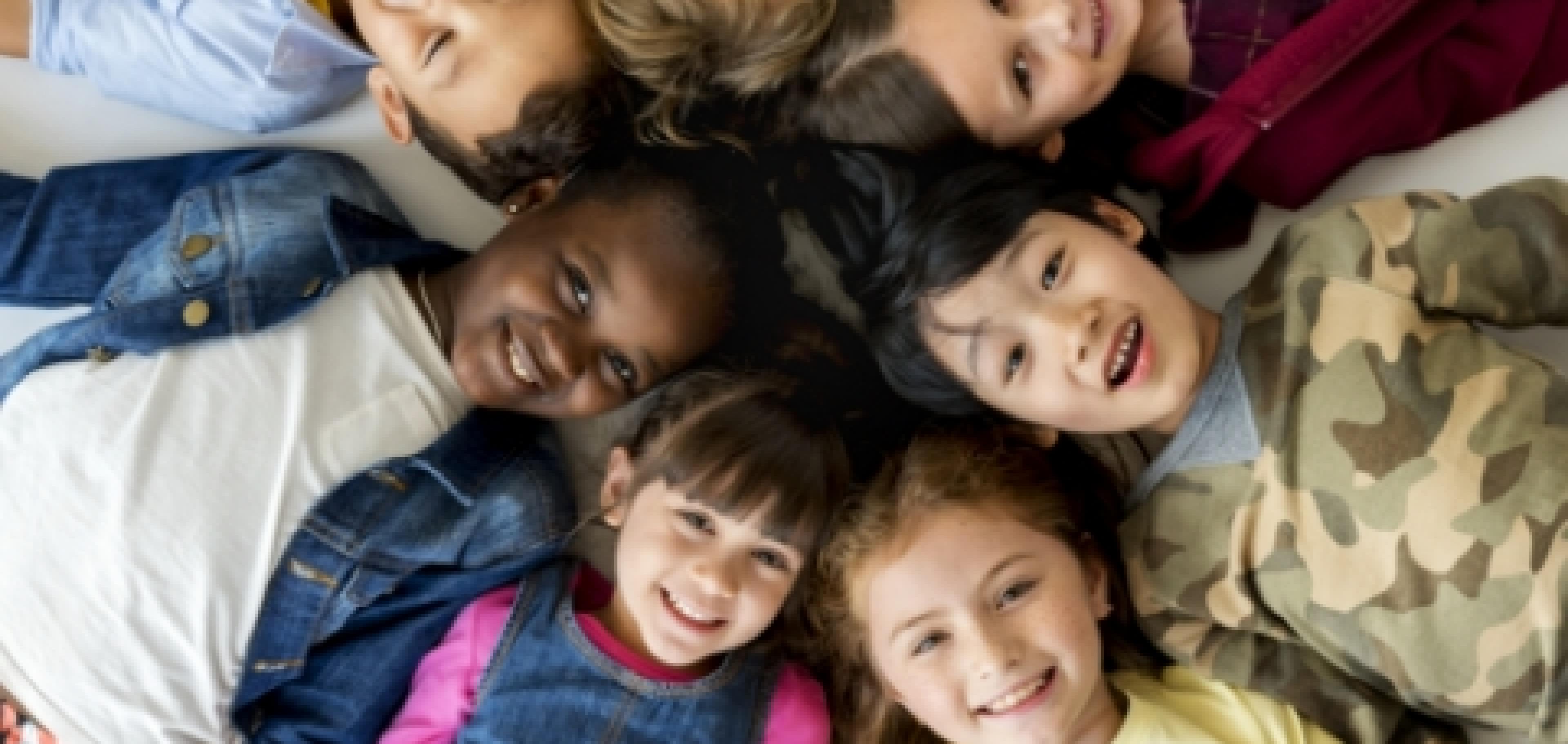 primary schoolers lying on the ground